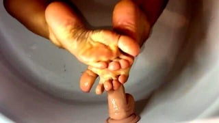 My feet are giving my dildo a nice treat